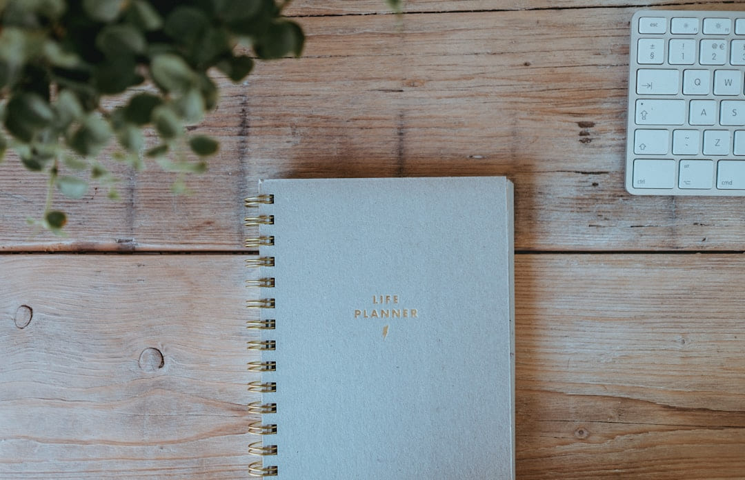 gray notebook on wood on Inner Progress Project