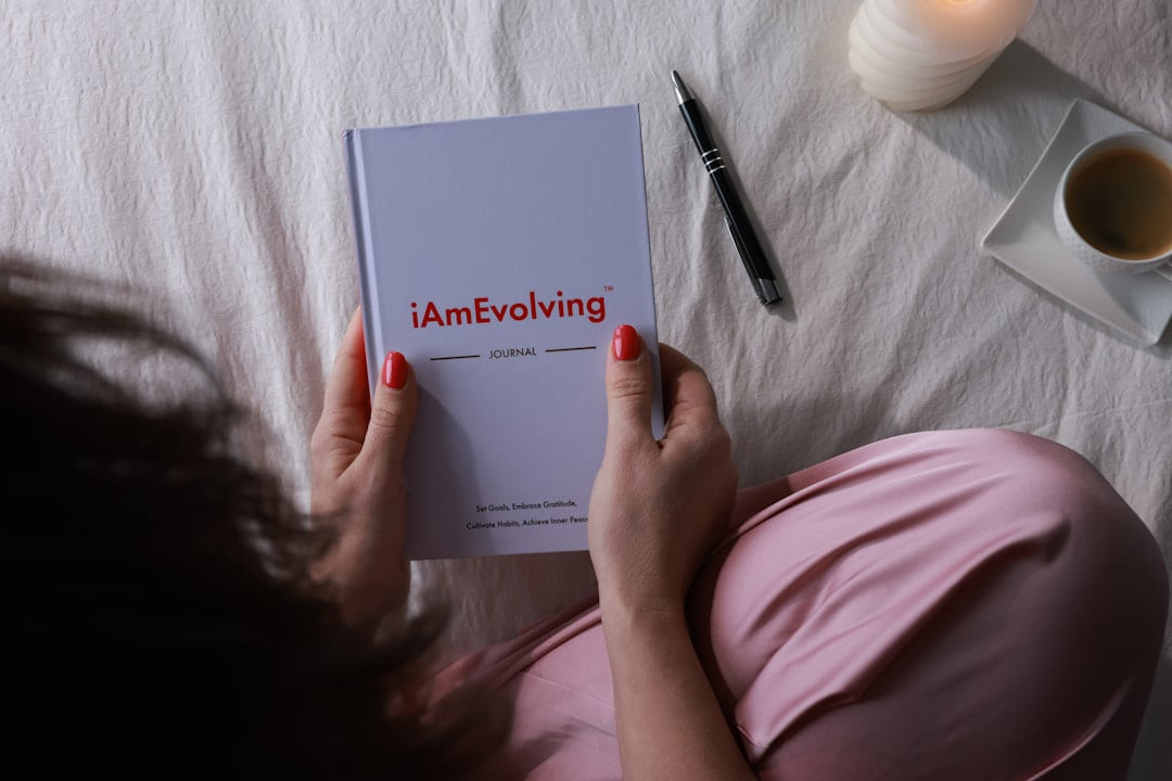 Woman reading a journal with a pen and coffee on Inner Progress Project