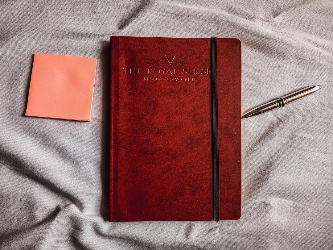 a red notebook with a pen on top of it on Inner Progress Project