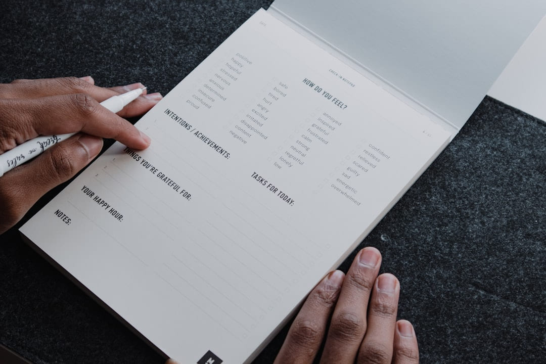 a person writing on a piece of paper on Inner Progress Project