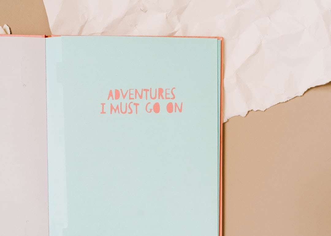 A pink and blue notebook sitting on top of a table on Inner Progress Project