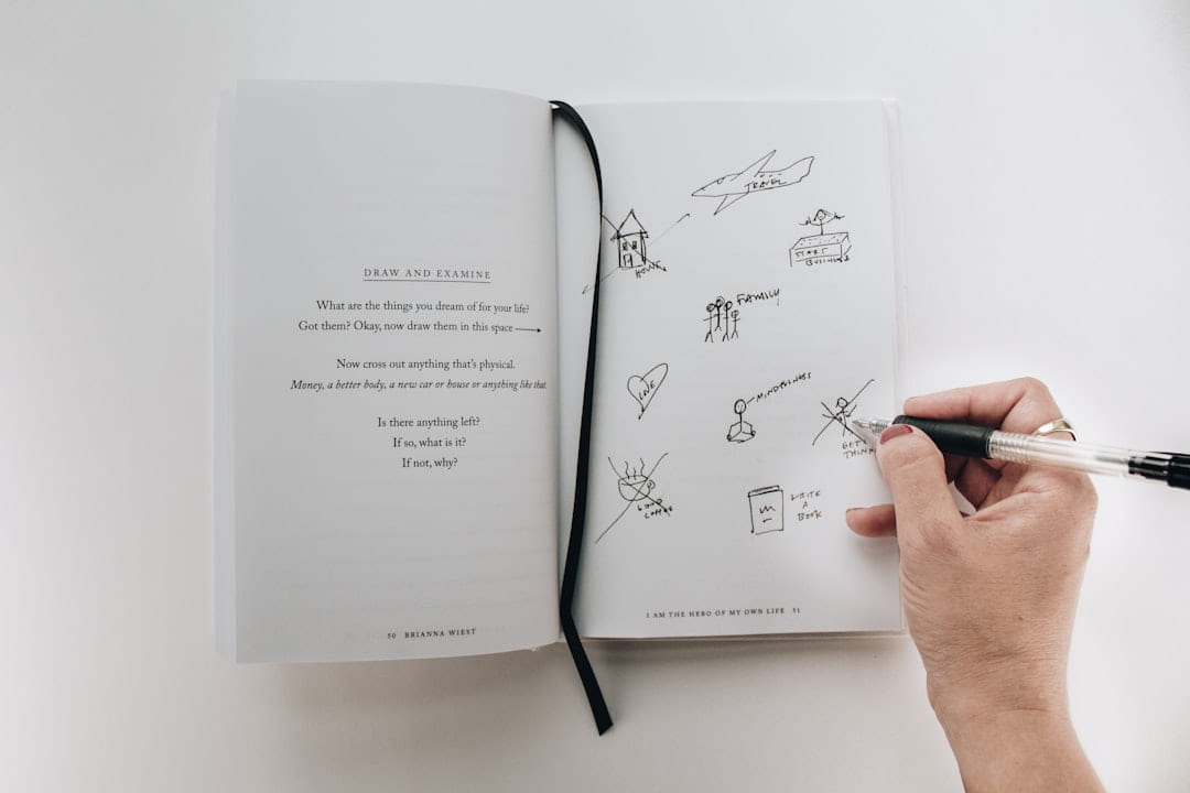 person writing on book on Inner Progress Project