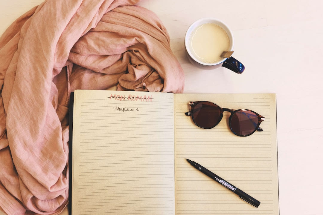 ballpoint pen and sunglasses on opened notebook on Inner Progress Project